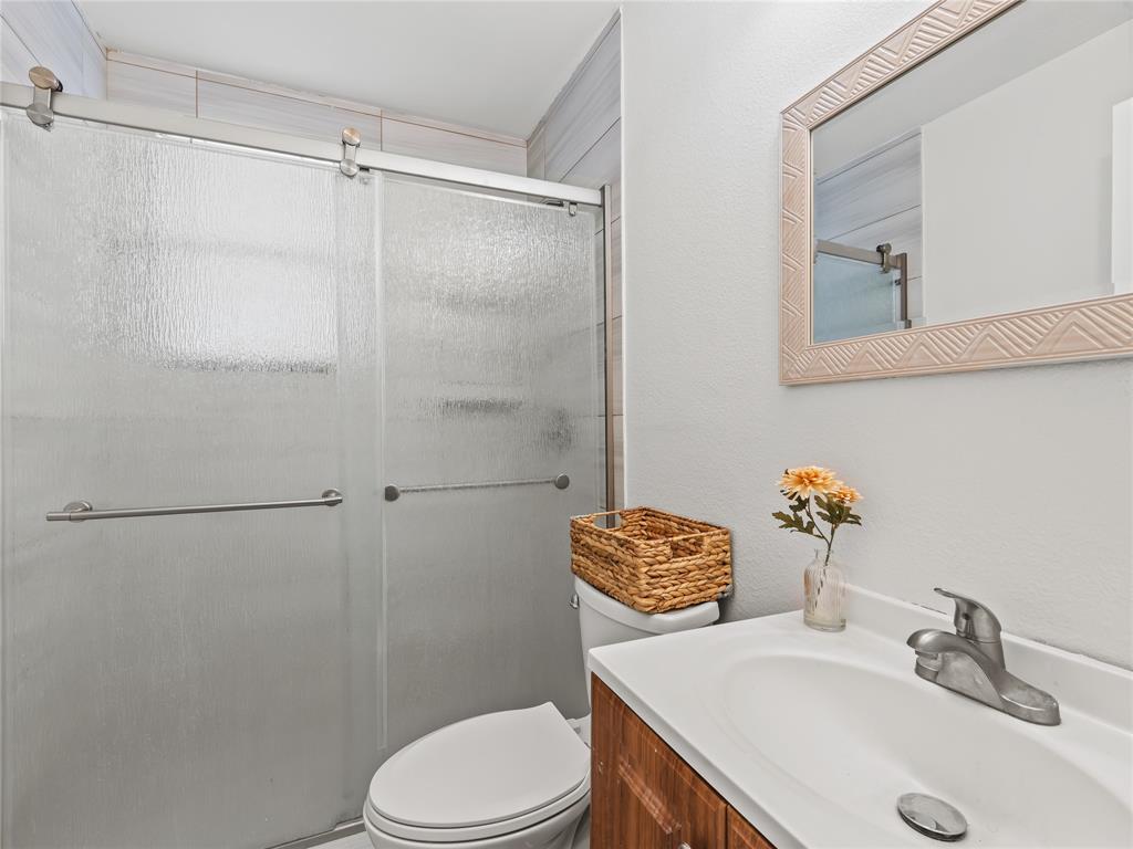 826 Ryan Road Dallas, TX 75224 - Photo 21 of 34 a bathroom with a sink a toilet and shower