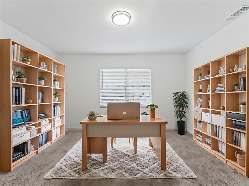 826 Ryan Road Dallas, TX 75224 - Photo 9 of 34 a living room with a book shelf and a book shelf