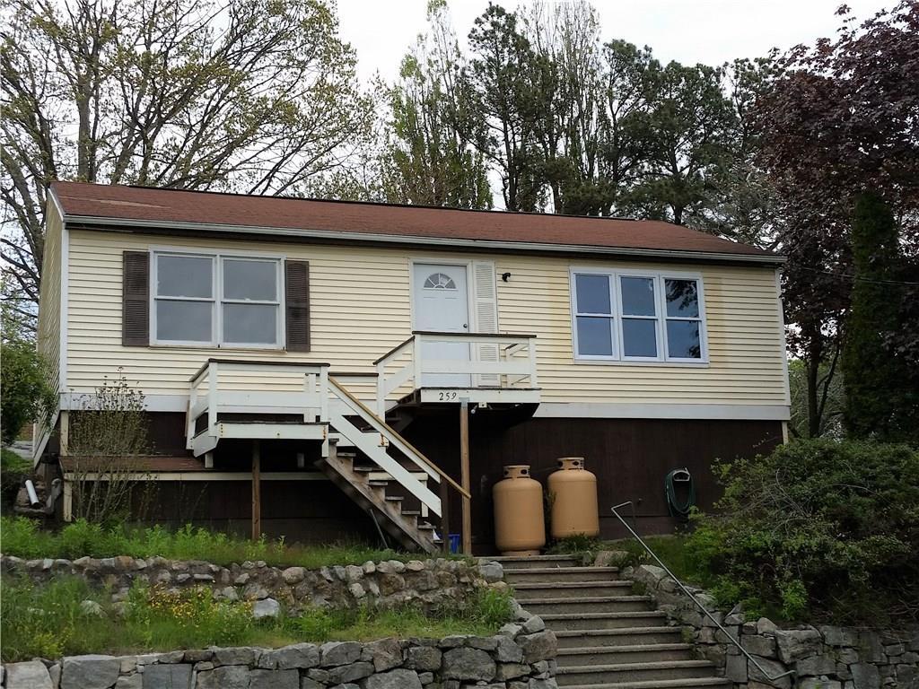 259 Elm Street New London, CT 06320 - Photo 1 of 1 a front view of house with yard and trees in the background