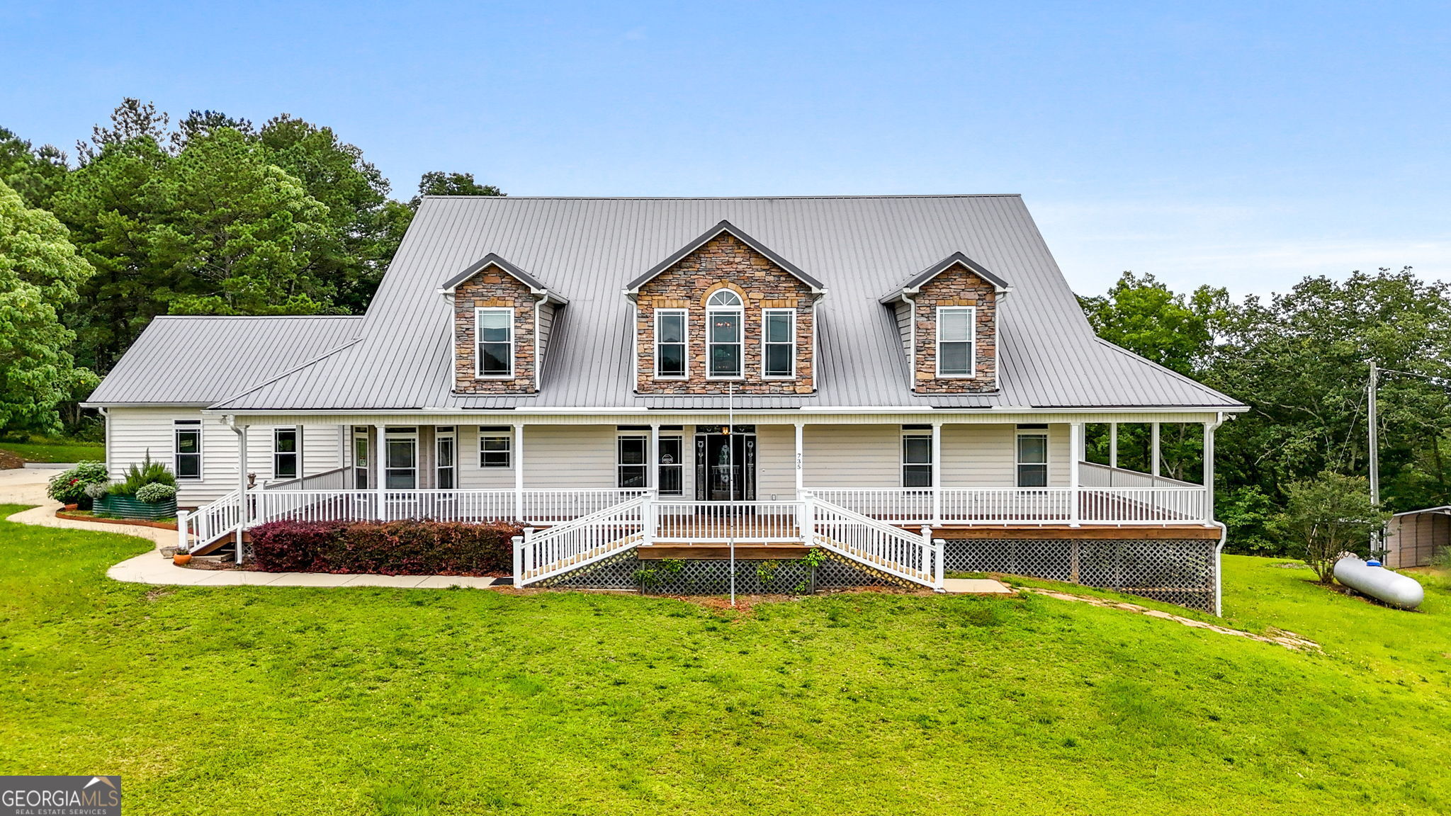 735 Firetower Road Thomaston, GA 30286 - Photo 5 of 112 a front view of a house with a yard table and chairs
