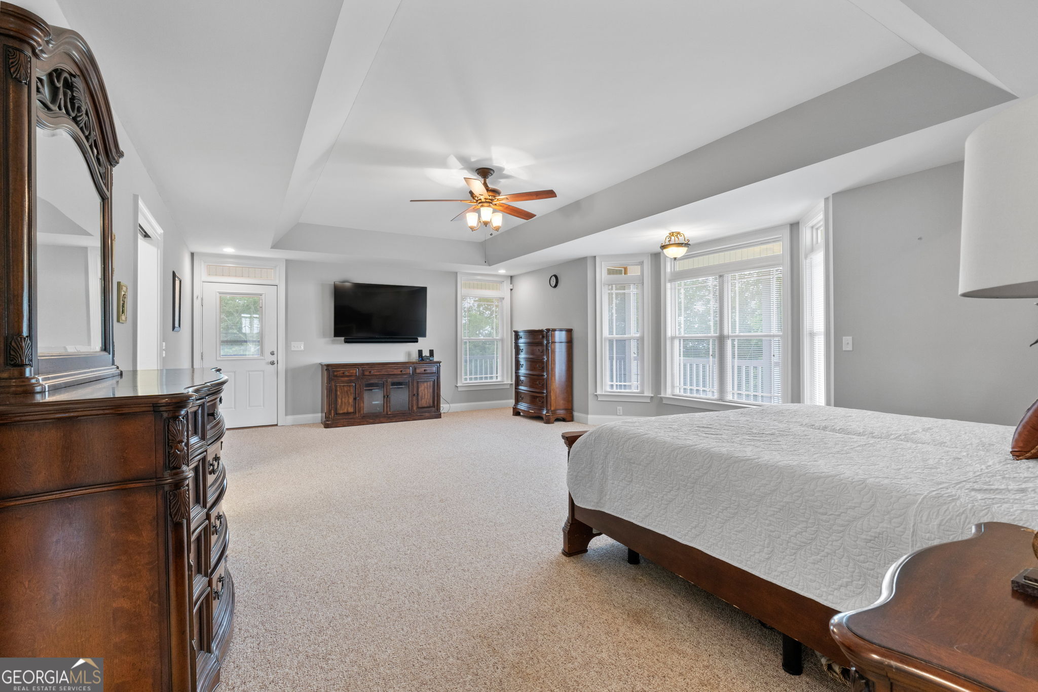 735 Firetower Road Thomaston, GA 30286 - Photo 66 of 112 a spacious bedroom with a bed and a flat screen tv