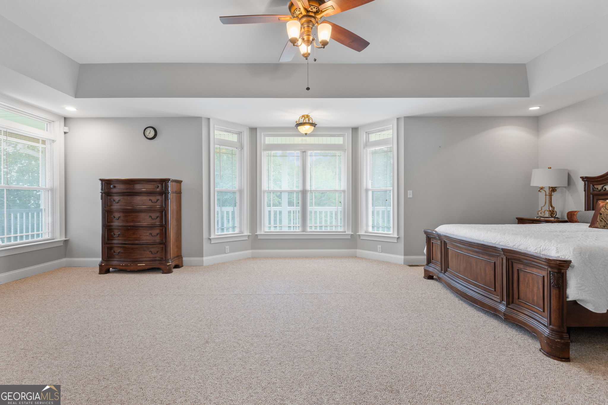 735 Firetower Road Thomaston, GA 30286 - Photo 68 of 112 a spacious bedroom with a bed and a chandelier