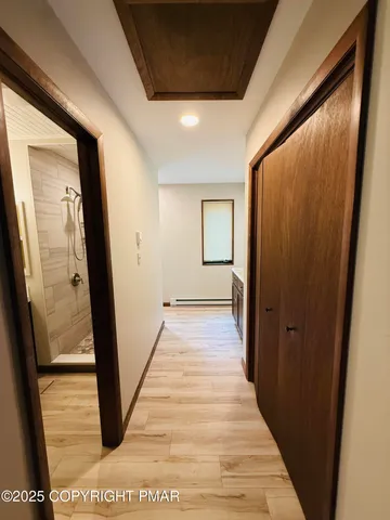 a view of a hallway with wooden floor and staircase