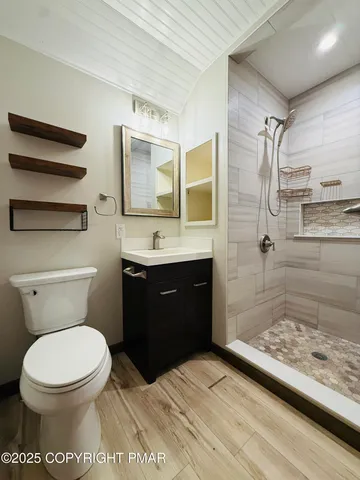 a bathroom with a toilet a sink and shower