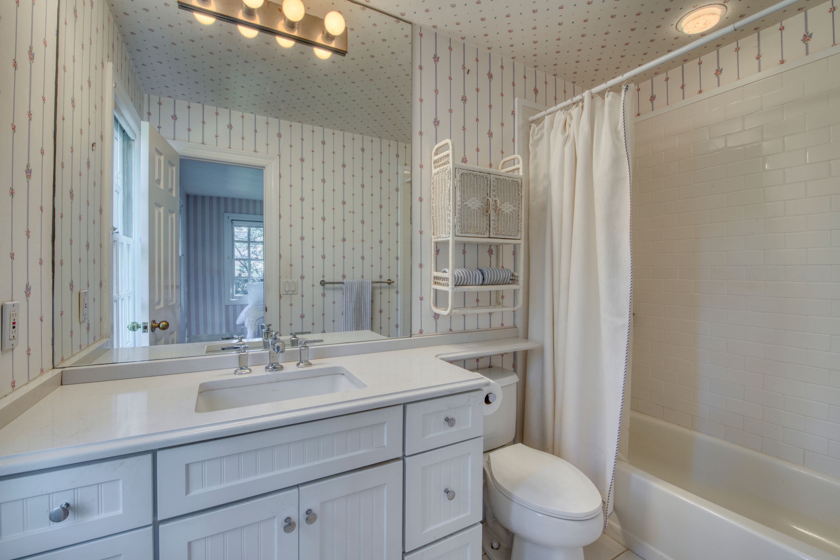 65 Skimhampton Road East Hampton, NY 11937 - Photo 11 of 16 a bathroom with a sink a mirror a toilet and shower