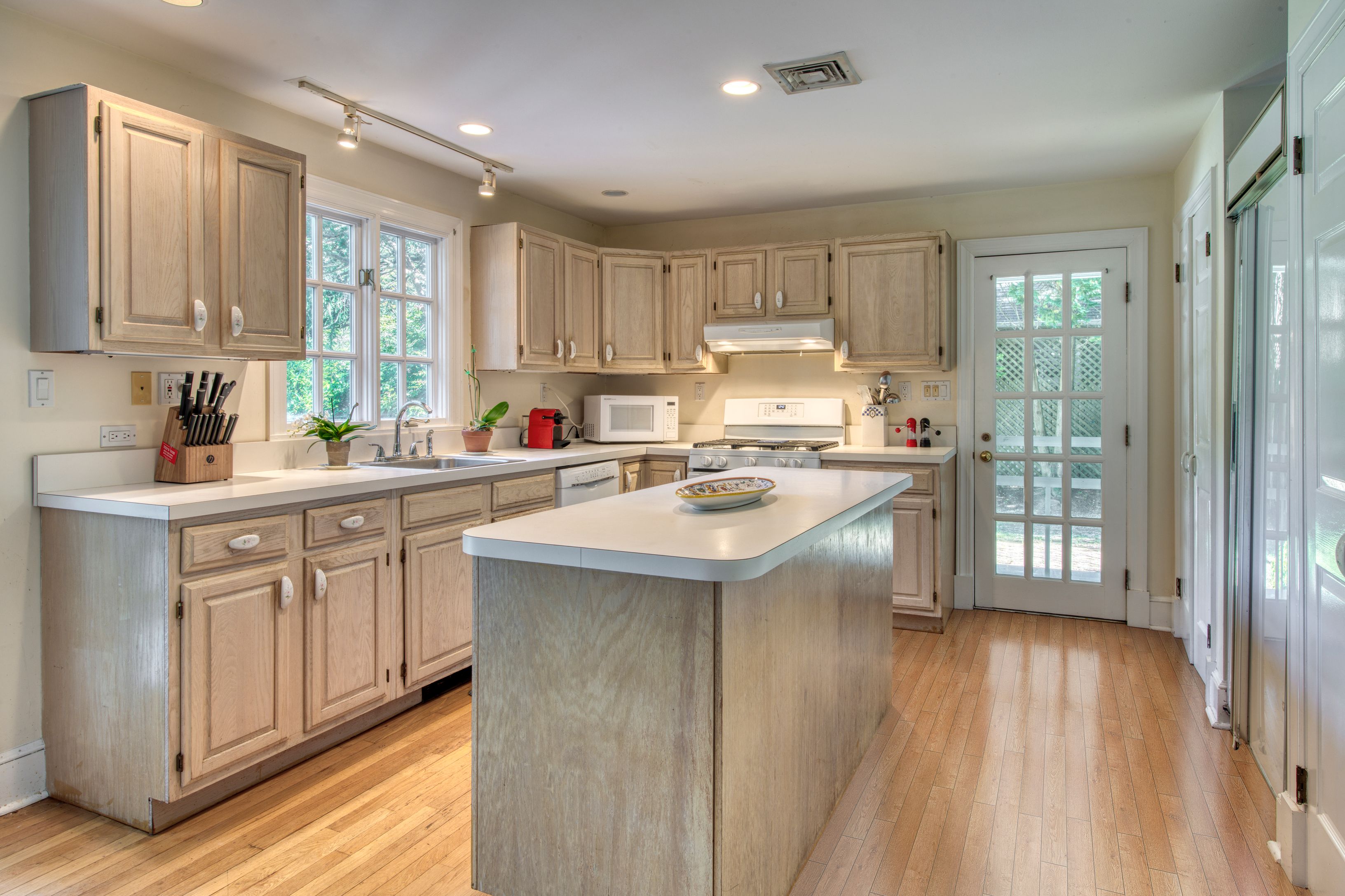 65 Skimhampton Road East Hampton, NY 11937 - Photo 6 of 16 a kitchen with kitchen island granite countertop a sink appliances cabinets and a counter top space