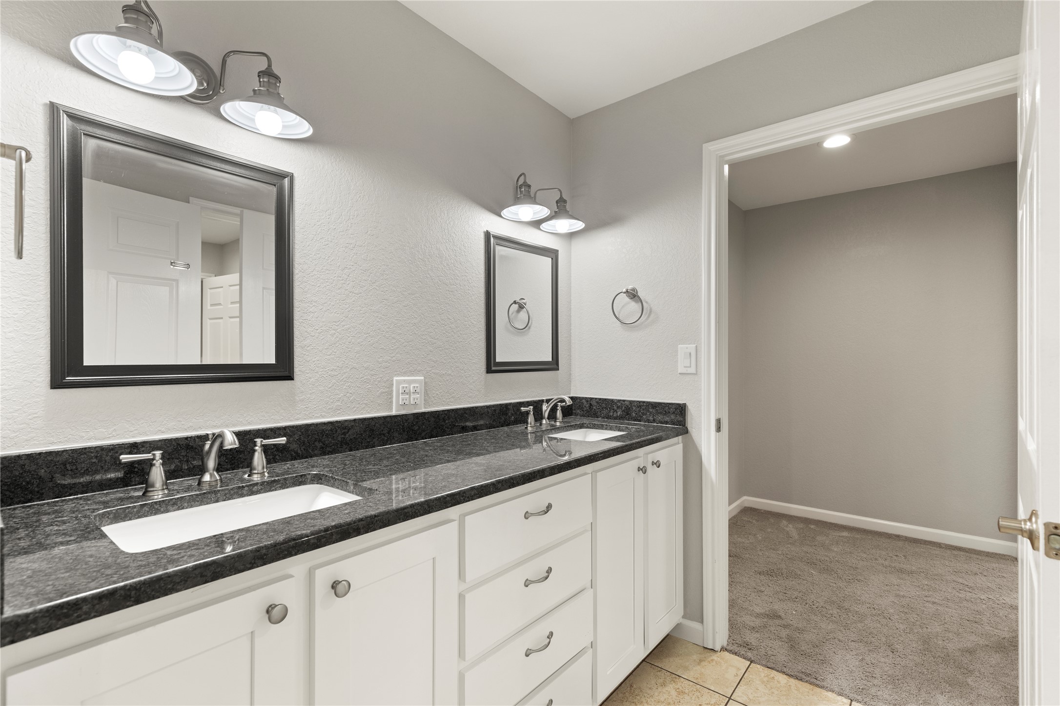 1293 Pioneer Road Seguin, TX 78155 - Photo 32 of 40 Double vanity with sleek granite counters provides ample space and elegant appeal.