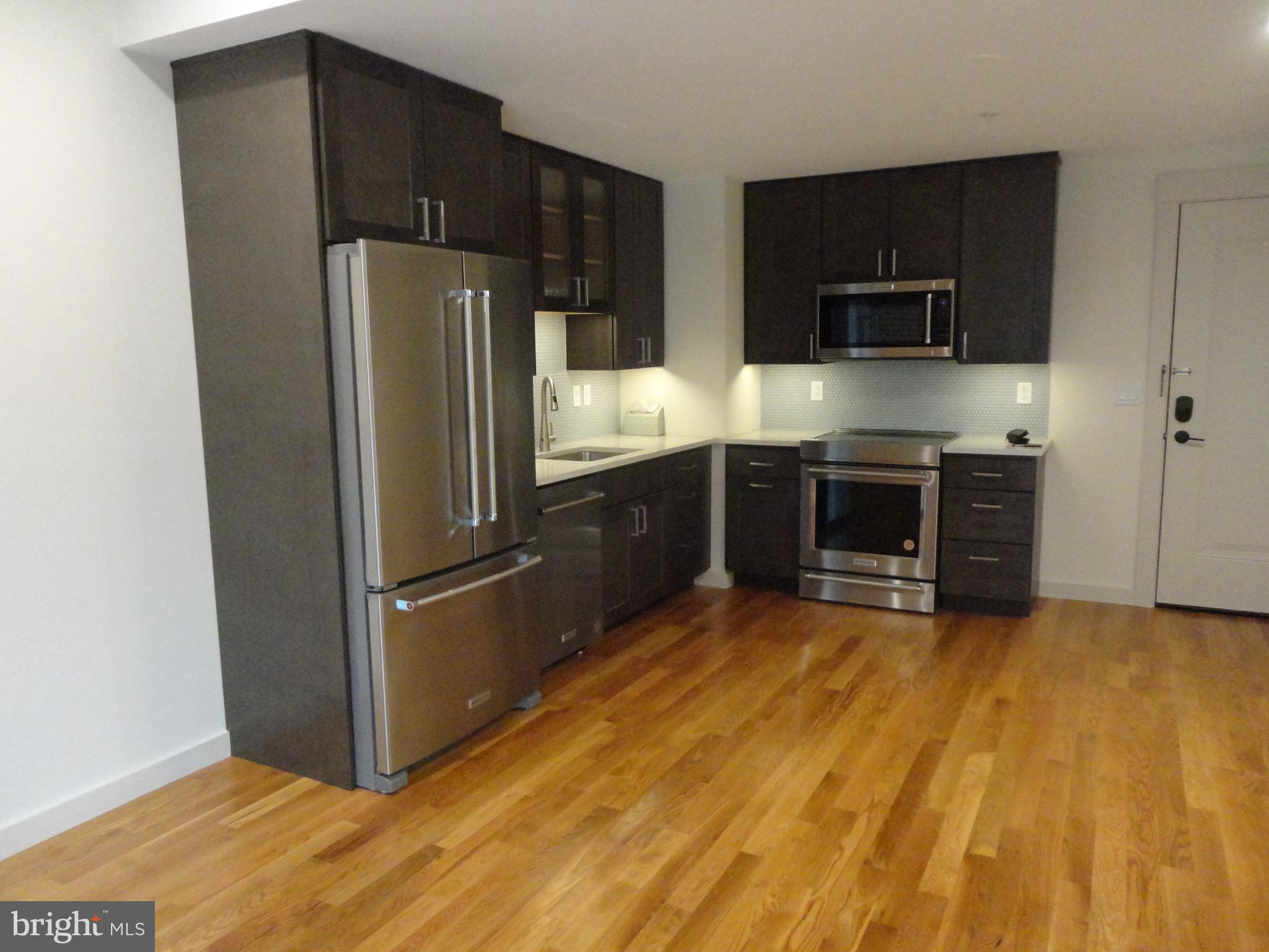 45 Spring Street, Unit 2 Princeton, NJ 08542 - Photo 2 of 22 a kitchen with stainless steel appliances a refrigerator and a stove top oven