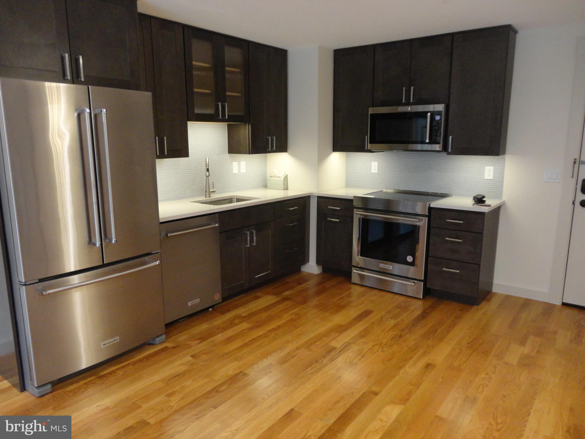 45 Spring Street, Unit 2 Princeton, NJ 08542 - Photo 3 of 22 a kitchen with stainless steel appliances granite countertop a refrigerator and a stove top oven
