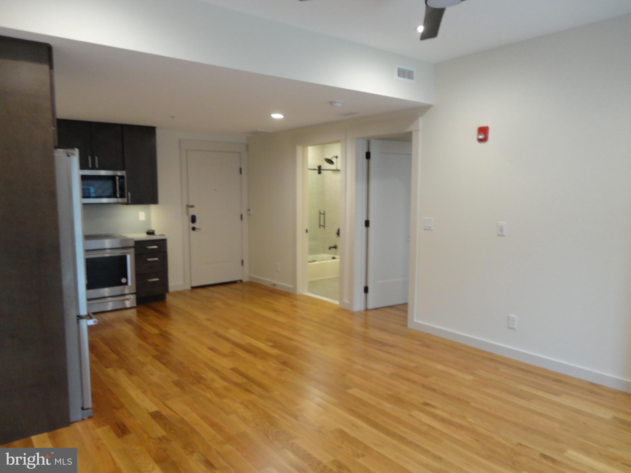 45 Spring Street, Unit 2 Princeton, NJ 08542 - Photo 4 of 22 a view of empty room with kitchen and window