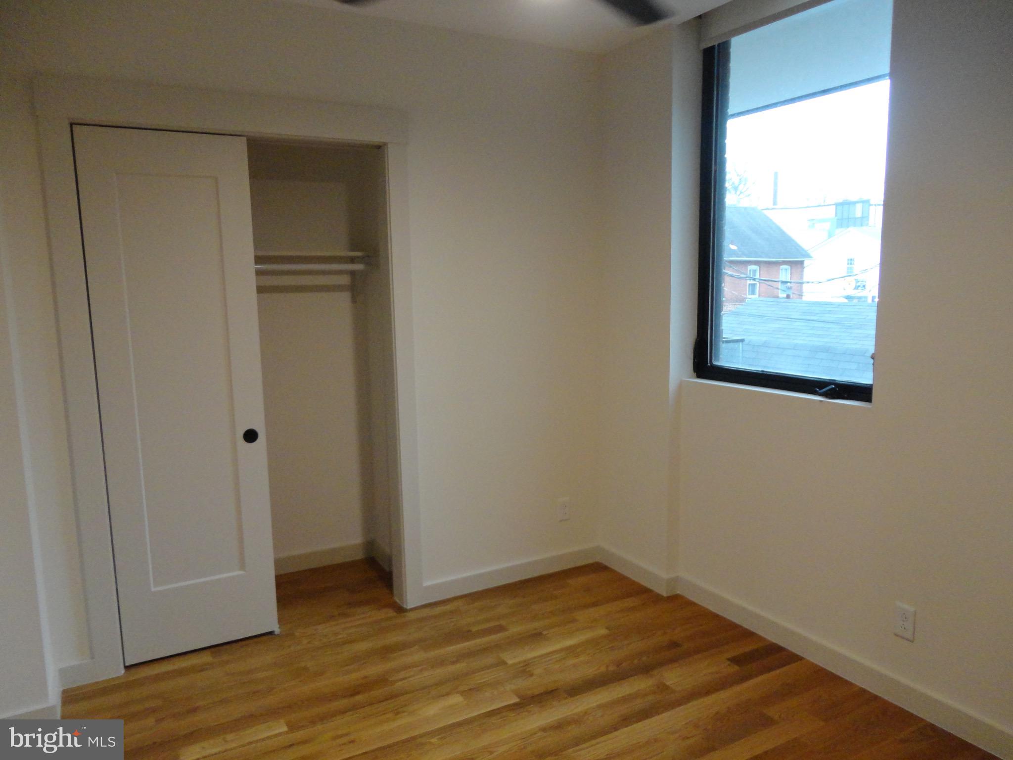 45 Spring Street, Unit 2 Princeton, NJ 08542 - Photo 9 of 22 a view of an empty room with wooden floor and a window