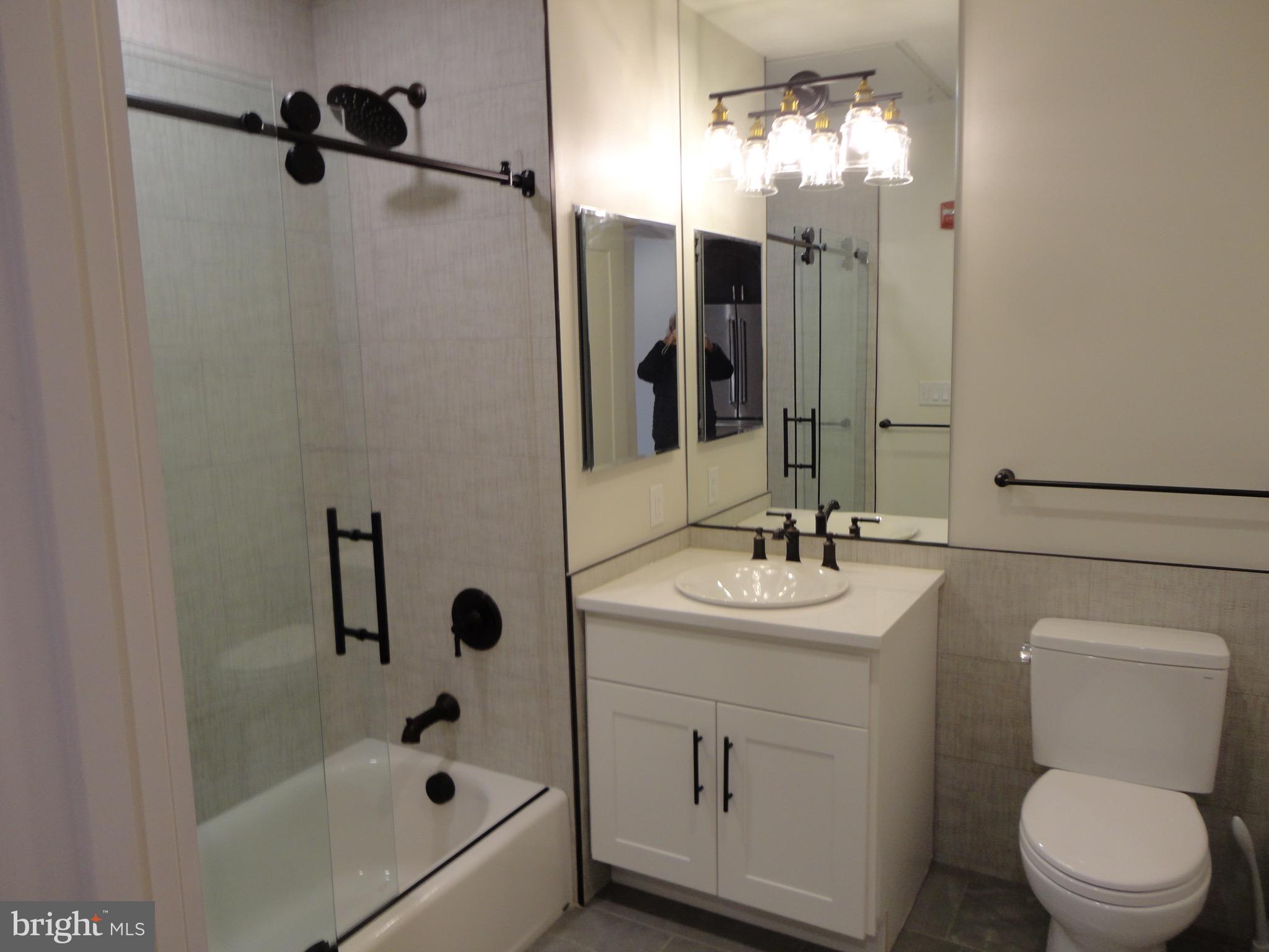 45 Spring Street, Unit 2 Princeton, NJ 08542 - Photo 10 of 22 a bathroom with a sink a toilet and shower