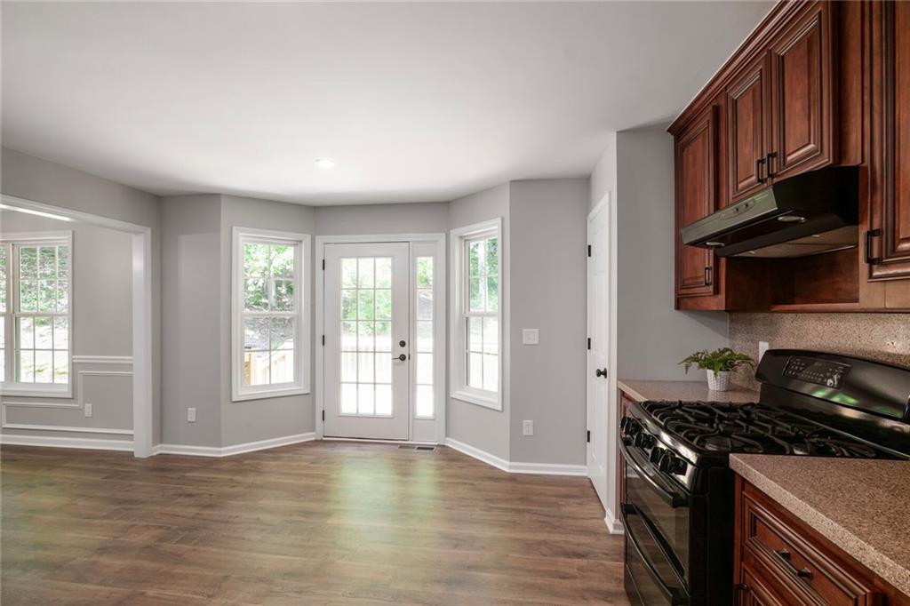 232 Barrett Springs Way Canton, GA 30115 - Photo 11 of 29 a kitchen with stainless steel appliances granite countertop a stove a sink and a refrigerator