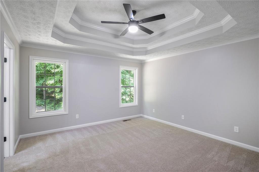 232 Barrett Springs Way Canton, GA 30115 - Photo 13 of 29 an empty room with a window and a fan