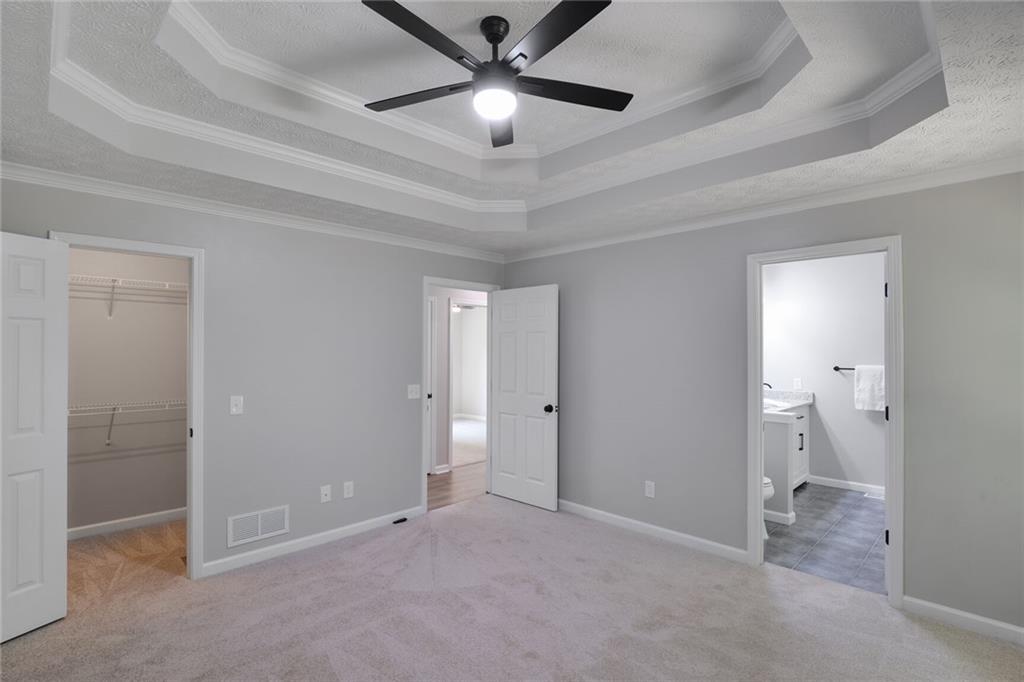 232 Barrett Springs Way Canton, GA 30115 - Photo 14 of 29 a view of an empty room and a ceiling fan