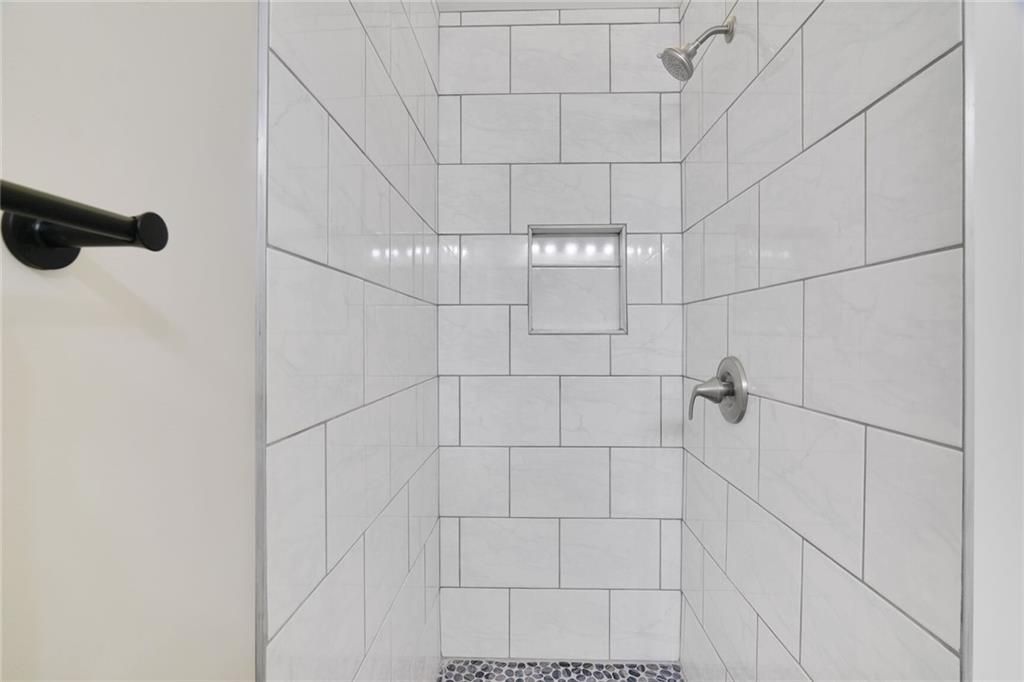 232 Barrett Springs Way Canton, GA 30115 - Photo 17 of 29 a bathroom with a shower