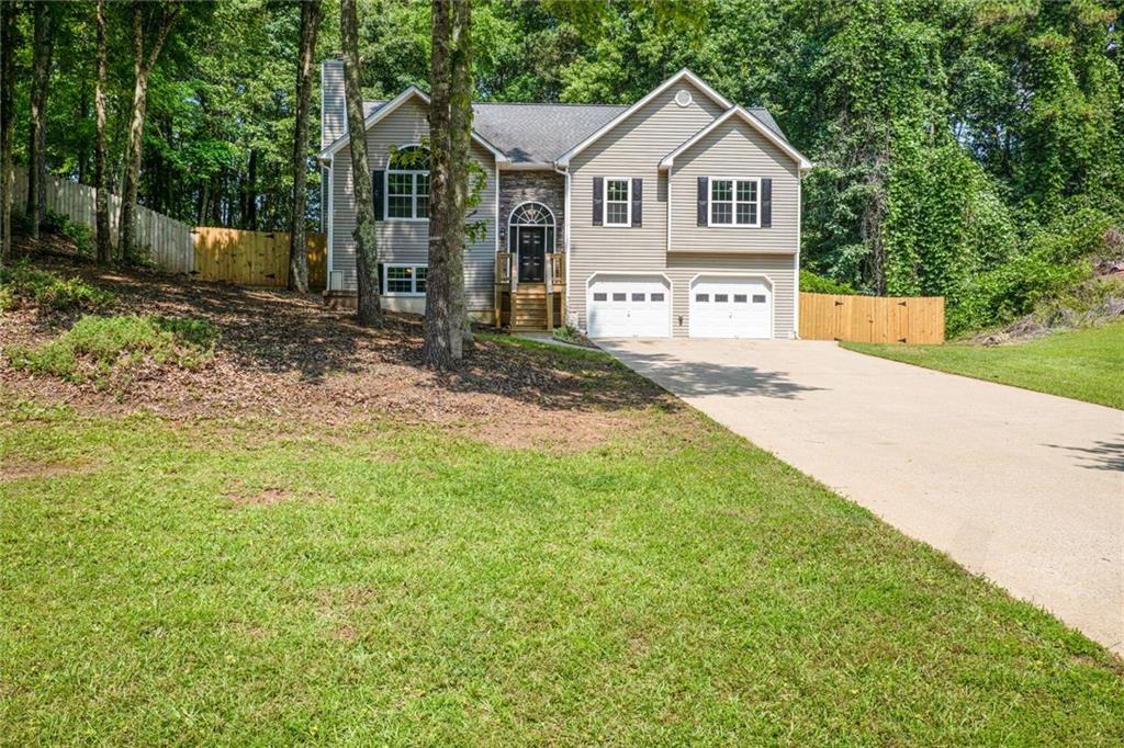 232 Barrett Springs Way Canton, GA 30115 - Photo 2 of 29 a front view of a house with a yard and garage