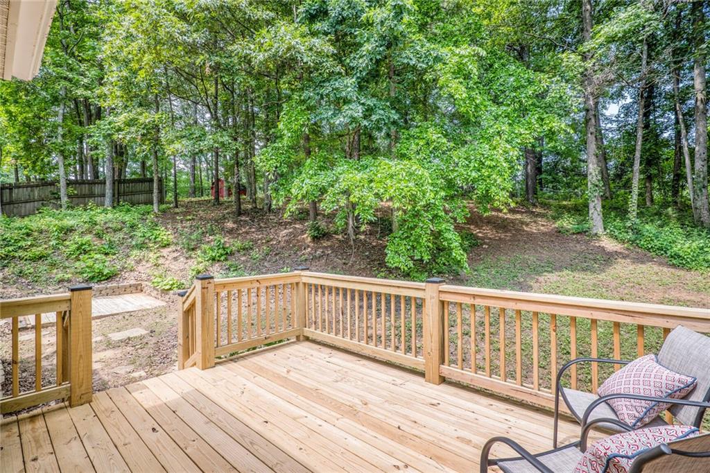 232 Barrett Springs Way Canton, GA 30115 - Photo 25 of 29 a view of a wooden deck with a yard
