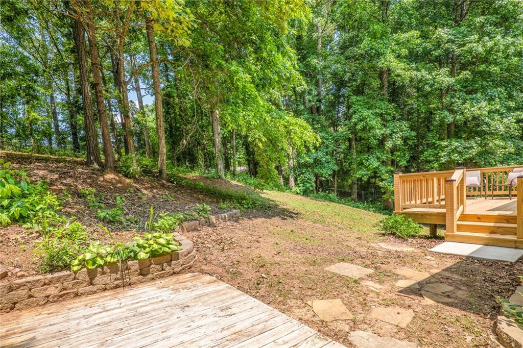 232 Barrett Springs Way Canton, GA 30115 - Photo 26 of 29 a view of a street with trees and bushes