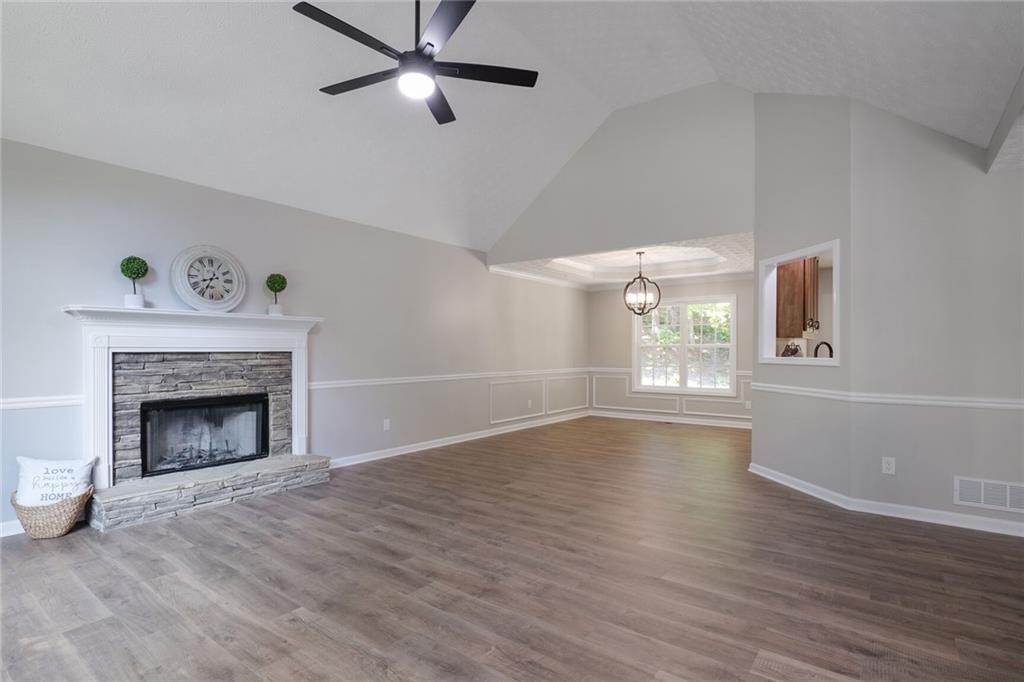 232 Barrett Springs Way Canton, GA 30115 - Photo 3 of 29 wooden floor fireplace and windows in an empty room