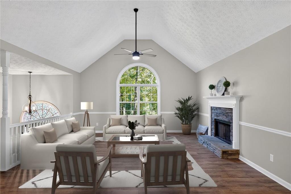 232 Barrett Springs Way Canton, GA 30115 - Photo 6 of 29 a living room with furniture a fireplace and a chandelier