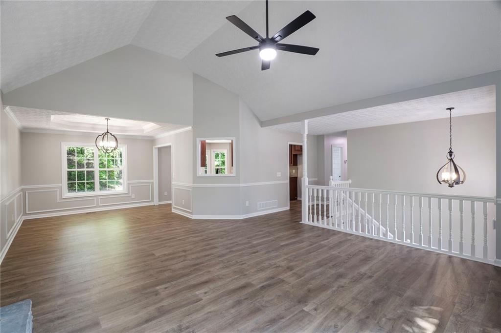 232 Barrett Springs Way Canton, GA 30115 - Photo 7 of 29 a view of an empty room with wooden floor and a window