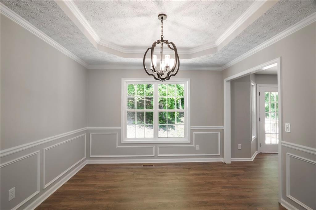 232 Barrett Springs Way Canton, GA 30115 - Photo 8 of 29 a view of empty room with wooden floor and fan