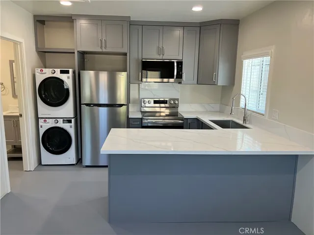 a kitchen with a stove a washer and dryer