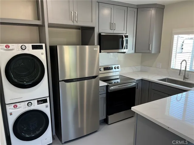 a kitchen with stainless steel appliances a refrigerator sink and cabinets