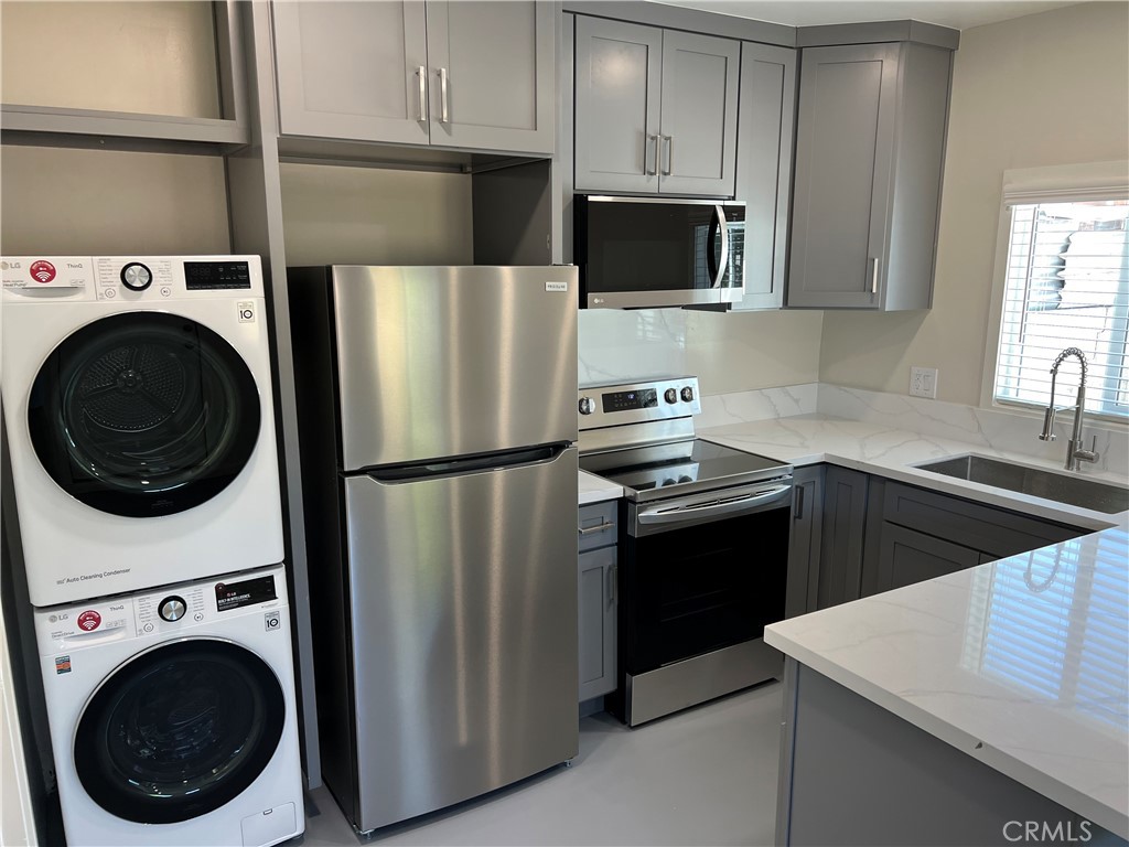 2290 Cogswell Road, Unit B El Monte, CA 91732 - Photo 7 of 12 a kitchen with stainless steel appliances a refrigerator sink and cabinets