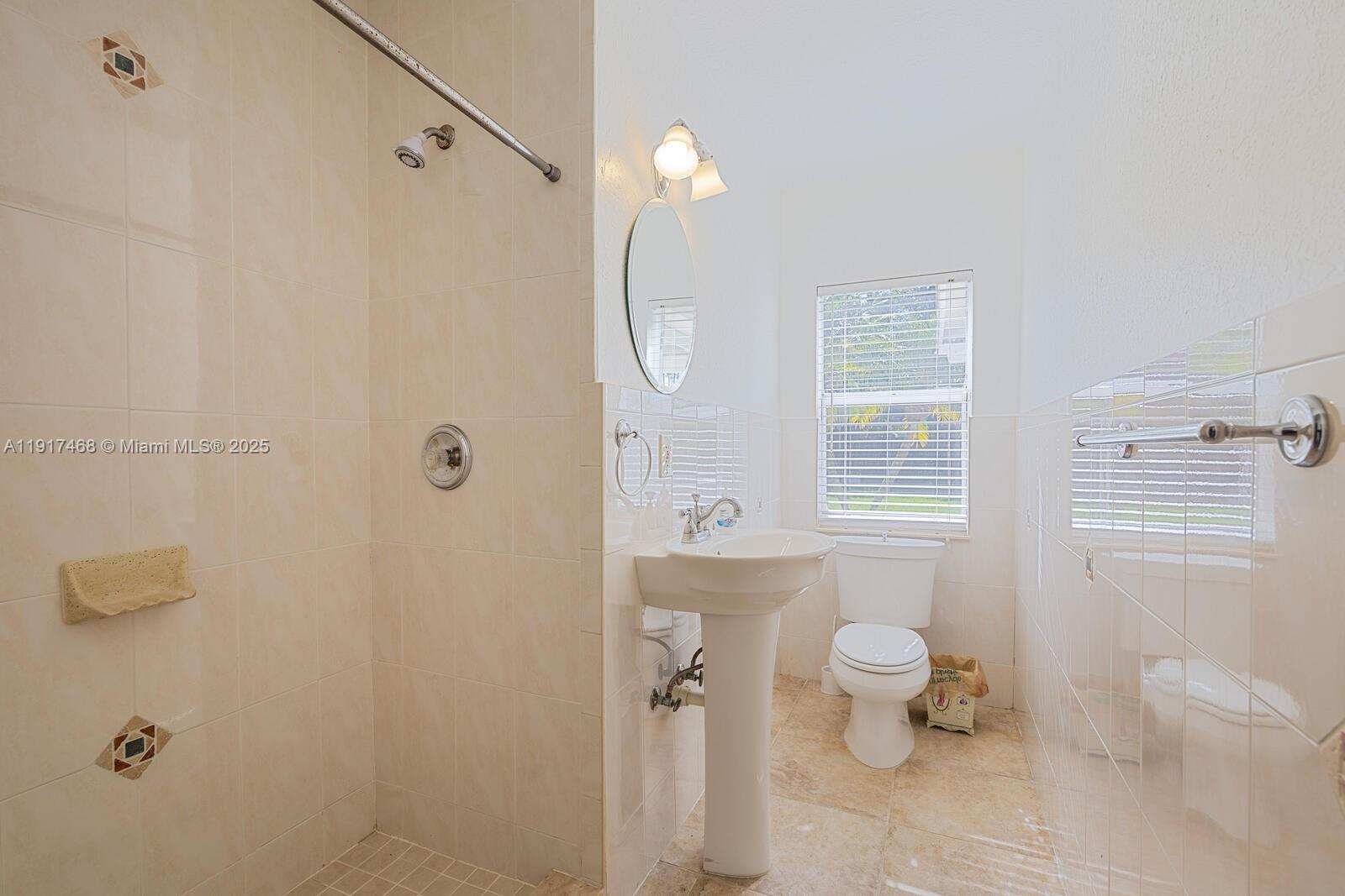 524 Northwest 14th Street Homestead, FL 33030 - Photo 31 of 37 a bathroom with a toilet a sink and shower