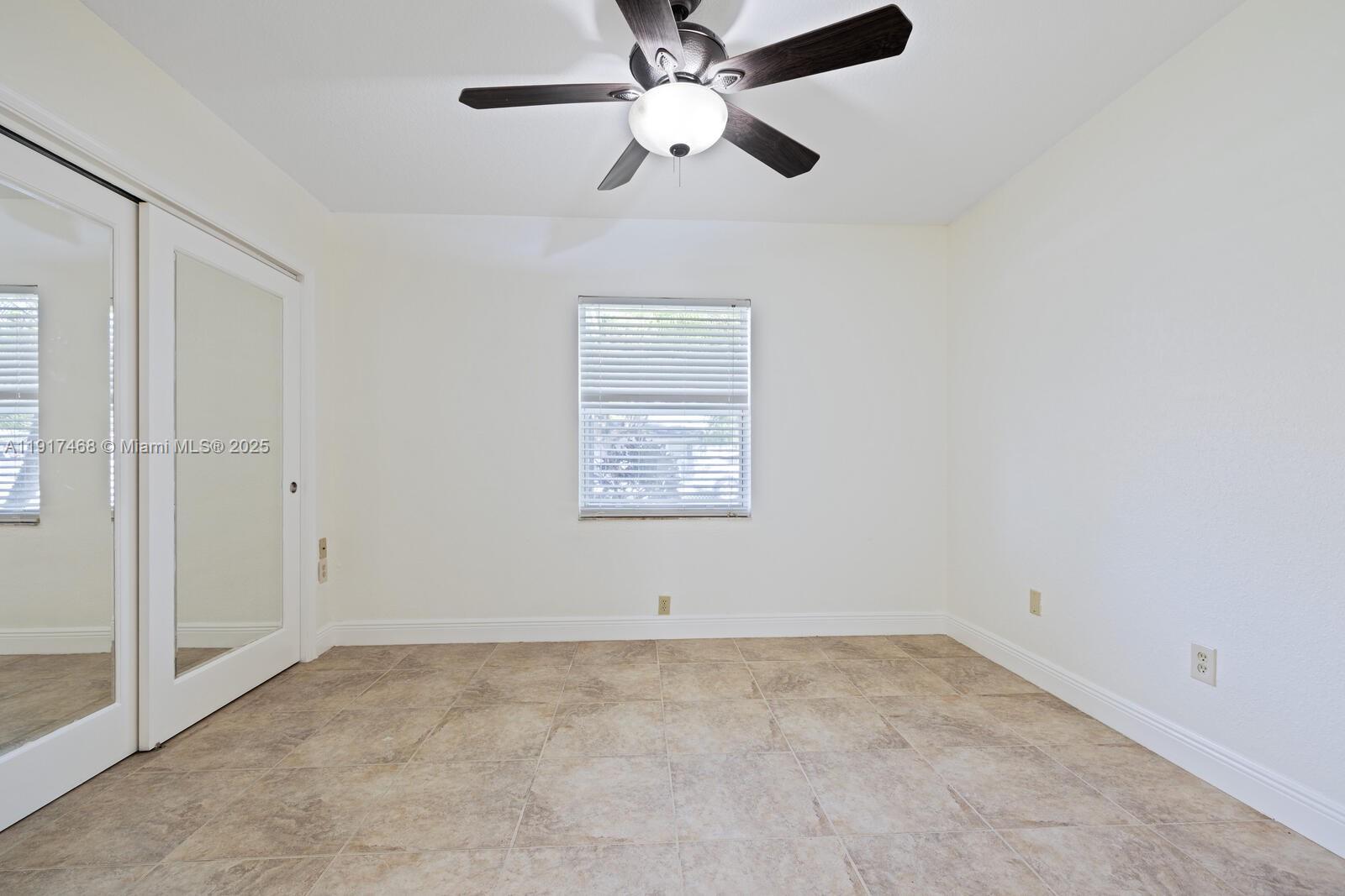 524 Northwest 14th Street Homestead, FL 33030 - Photo 32 of 37 en empty room with ceiling fan and window