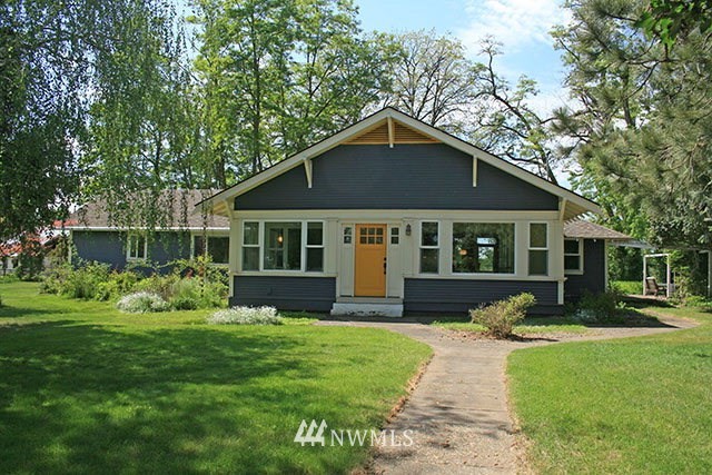 337 Mission Road Walla Walla, WA 99362 - Photo 1 of 23 a front view of a house with a yard table and chairs