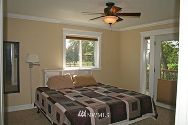337 Mission Road Walla Walla, WA 99362 - Photo 8 of 23 a bedroom with a bed and a chandelier