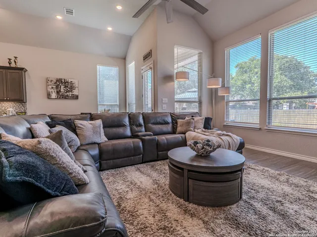 a living room with furniture and a large window