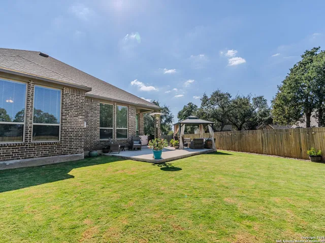 a view of a house with swimming pool and sitting area