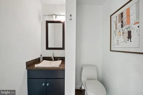 a spacious bedroom with a large bed and a potted plant