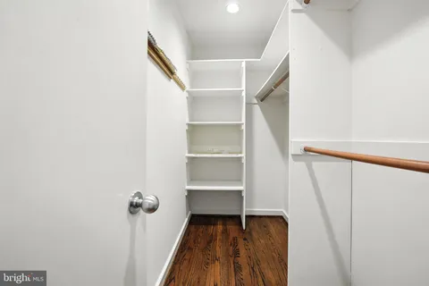 a view of empty room with wooden floor and fireplace