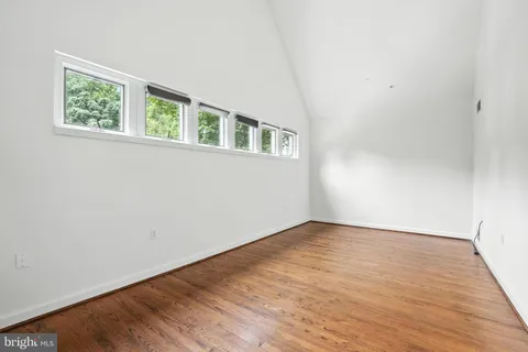 a view of kitchen with stainless steel appliances a refrigerator and wooden floor