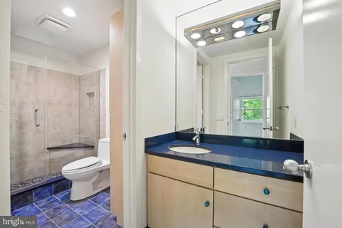 a view of an empty room with wooden floor and windows