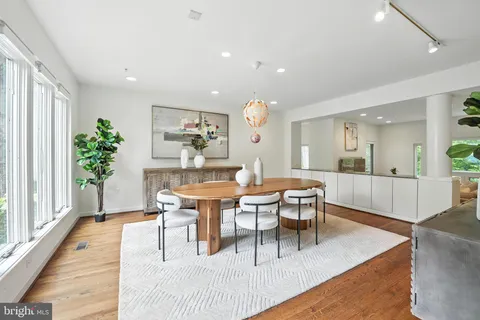 a large kitchen with stainless steel appliances granite countertop a lot of counter space a sink and a wooden floors