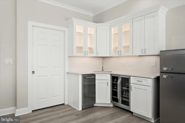 a living room with furniture and large windows