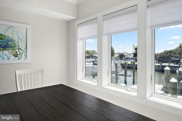 a bedroom with a bed and a flat tv screen on dresser