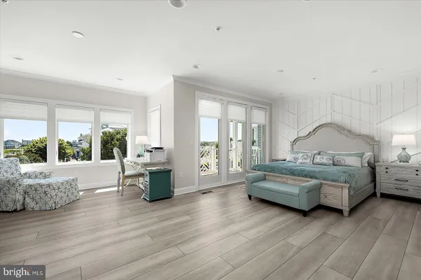 a kitchen with stainless steel appliances granite countertop a stove a sink dishwasher a dining table and chairs with wooden floor