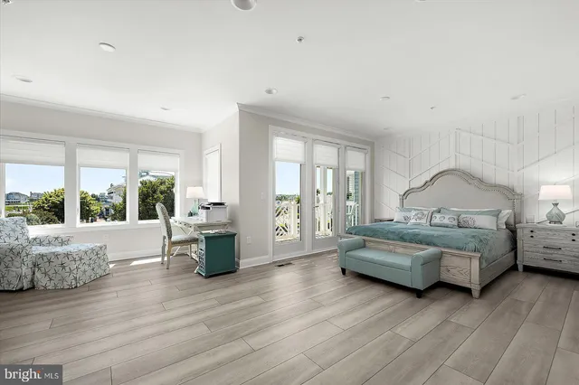 a kitchen with stainless steel appliances granite countertop a stove a sink dishwasher a dining table and chairs with wooden floor