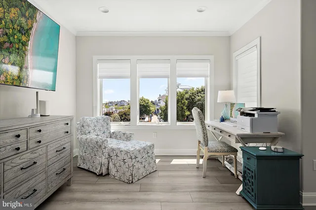 a living room with furniture and a floor to ceiling window