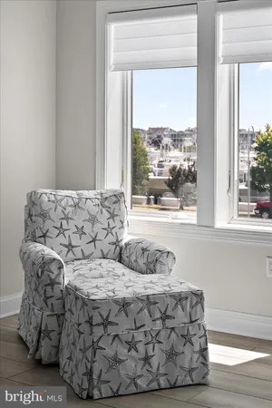 a living room with furniture and a floor to ceiling window