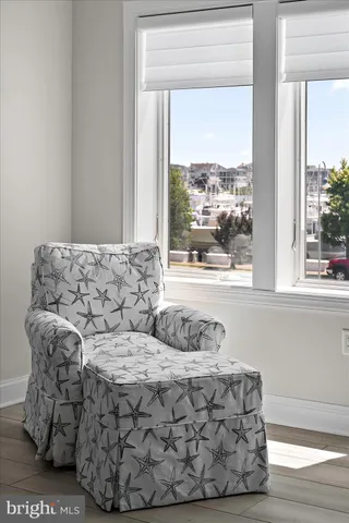 a living room with furniture and a floor to ceiling window