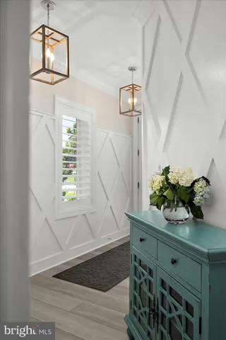 a living room with furniture a couch and a potted plant