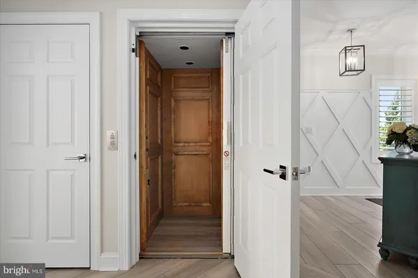 a kitchen with stainless steel appliances granite countertop a stove top oven a sink a dining table and chairs